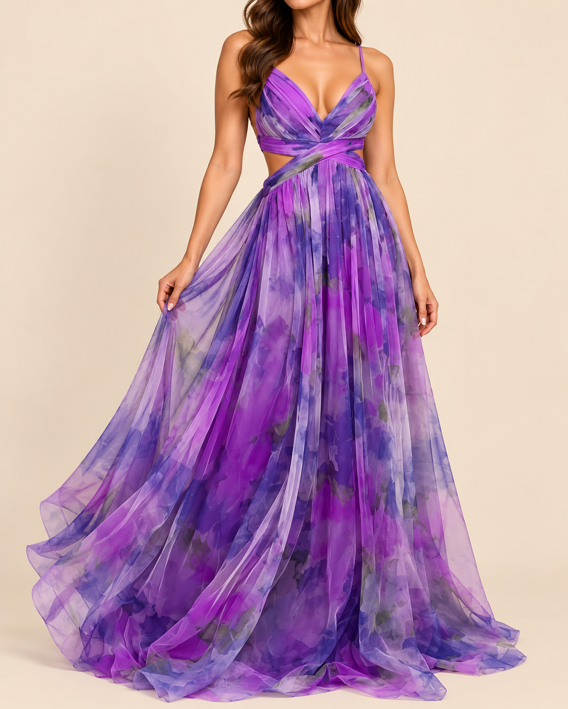 A woman modeling a floor-length purple and violet tie-dye chiffon gown with spaghetti straps, a crossover sweetheart neckline, and a side cutout at the waist, set against a solid beige background.